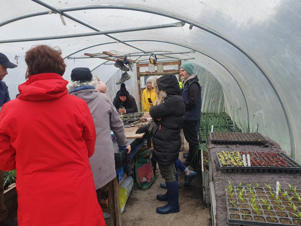 a group of people in a greenhouse